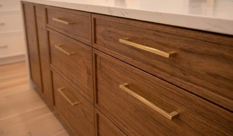 Walnut kitchen drawers with brushed brass pulls